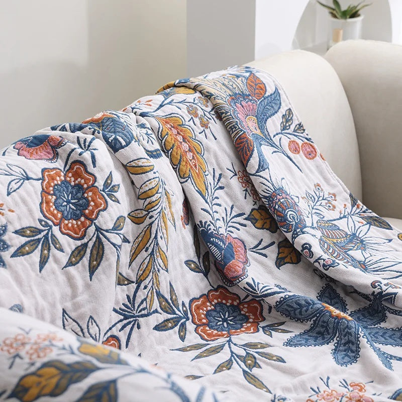 Coperta con nappine in cotone floreale